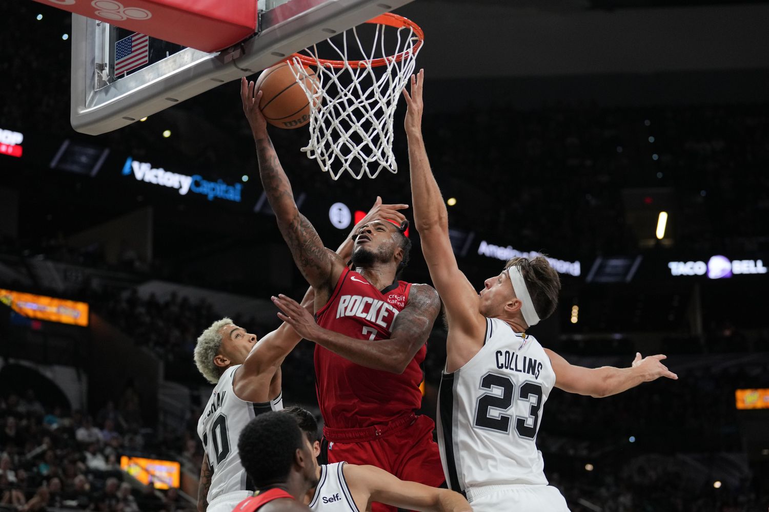 Rockets forward Cam Whitmore shoots between San Antonio Spurs forwards Jeremy Sochan (10) and Zach Collins in the second half at the Frost Bank Center.